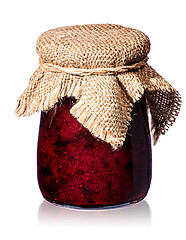 Image showing Currant jam in jar with burlap