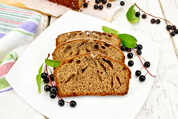 Image showing Fruitcake bird cherry in plate on light board