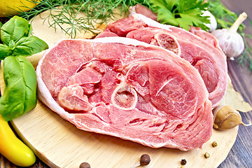 Image showing Turkey steak raw with garlic on board