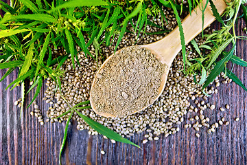 Image showing Flour hemp in spoon with leaf and grain on board top