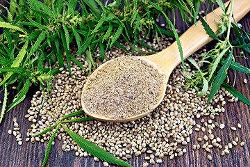 Image showing Flour hemp in spoon with leaf on dark board