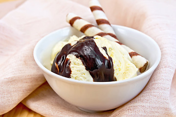 Image showing Ice cream vanilla with wafer rolls on napkin