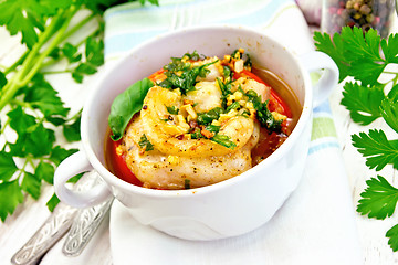 Image showing Fish baked with tomato and spices in white bowl on board