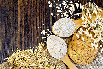 Image showing Flour oat with bran in spoons and cookies on board