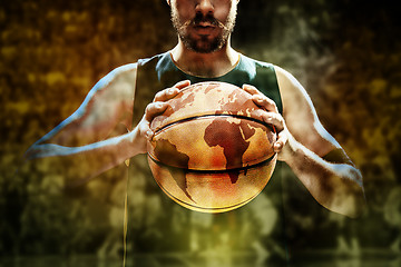 Image showing Silhouette view of a basketball player holding basket ball on black background