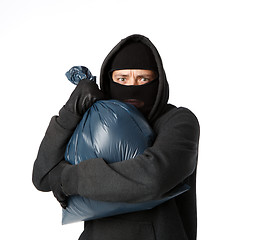 Image showing Terrible robber holding large bag