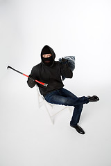 Image showing Robber sitting on white chair