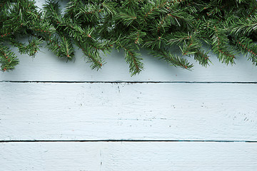 Image showing Christmas fir tree on light blue wooden plank with copyspace