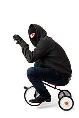 Image showing Robber on small children\'s bicycle