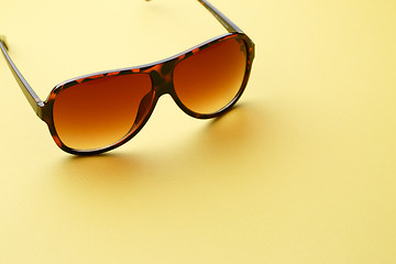 Image showing Sunglasses in empty yellow background