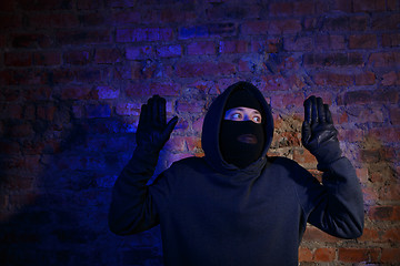 Image showing Surprised burglar with hands up