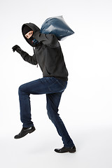 Image showing Thief in gloves with bag