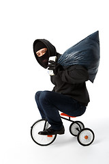 Image showing Burglar coming on children\'s bike