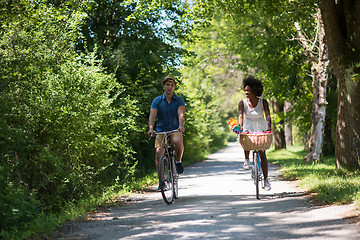 Image showing Young multiethnic couple having a bike ride in nature