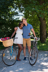 Image showing Young multiethnic couple having a bike ride in nature