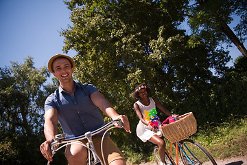 Image showing Young multiethnic couple having a bike ride in nature