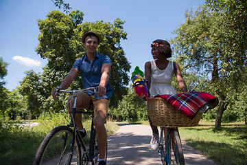 Image showing Young multiethnic couple having a bike ride in nature