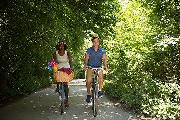 Image showing Young multiethnic couple having a bike ride in nature