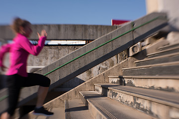 Image showing woman jogging on  steps