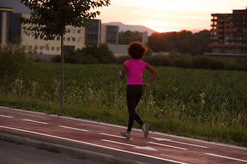 Image showing a young African American woman jogging outdoors