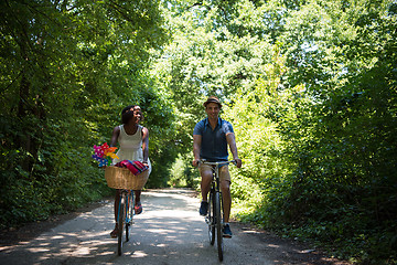 Image showing Young multiethnic couple having a bike ride in nature