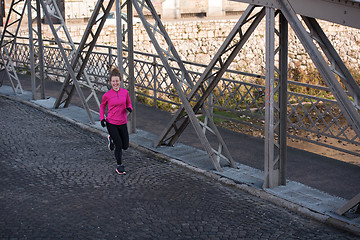 Image showing sporty woman jogging on morning