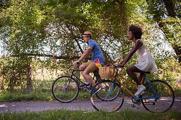 Image showing Young multiethnic couple having a bike ride in nature