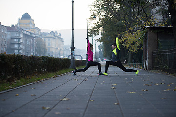 Image showing a young couple warming up before jogging