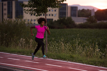 Image showing a young African American woman jogging outdoors