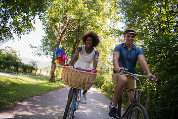 Image showing Young multiethnic couple having a bike ride in nature