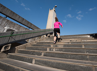 Image showing woman jogging on  steps