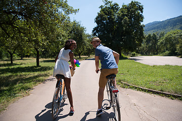 Image showing Young multiethnic couple having a bike ride in nature