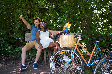 Image showing Young multiethnic couple having a bike ride in nature