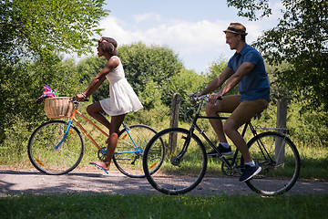 Image showing Young multiethnic couple having a bike ride in nature