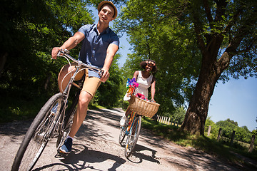 Image showing Young multiethnic couple having a bike ride in nature