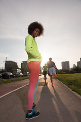 Image showing Portrait of sporty young african american woman running outdoors