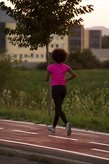 Image showing a young African American woman jogging outdoors