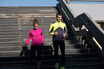 Image showing young  couple jogging on steps