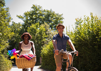 Image showing Young multiethnic couple having a bike ride in nature