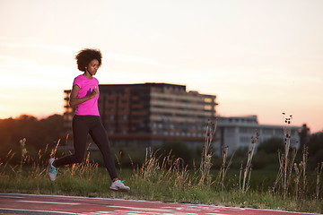 Image showing a young African American woman jogging outdoors