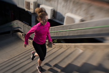 Image showing woman jogging on  steps