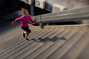 Image showing woman jogging on  steps