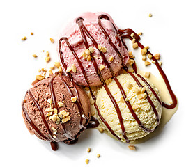 Image showing various ice cream balls with chocolate sauce