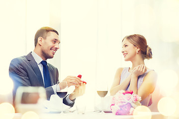 Image showing man proposing to his girlfriend at restaurant