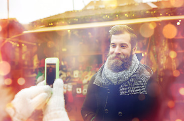 Image showing couple taking picture with smartphone in old town