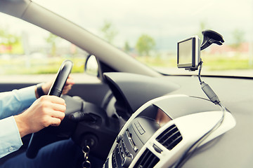 Image showing close up of man with gps navigator driving car