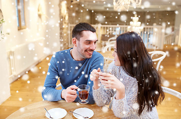 Image showing happy couple drinking tea at cafe