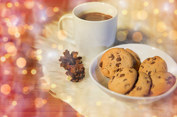 Image showing cups of hot chocolate with cookies on fur rug