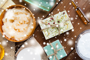 Image showing body scrub and handmade soap bars on wood