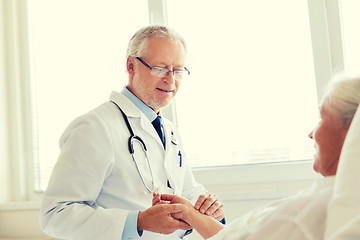 Image showing doctor checking senior woman pulse at hospital